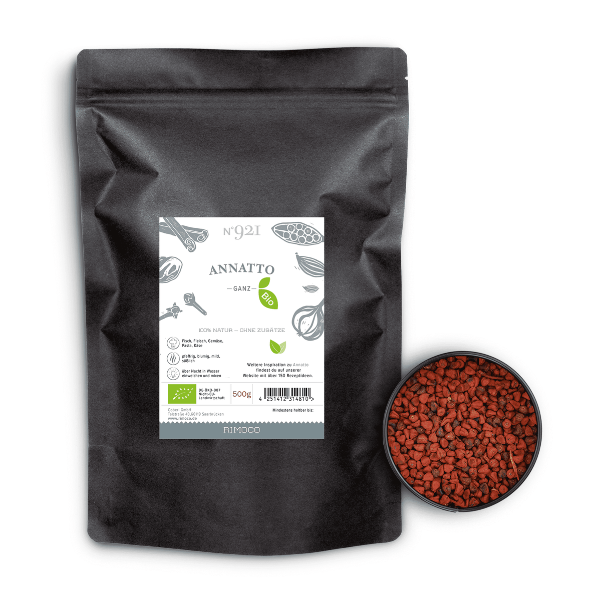 Schwarzer Bio Annatto Beutel neben einer Schale mit kleinen roten Annattosamen.