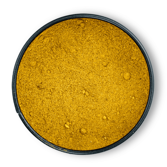 Rundes schwarzes Gefäß mit Bio Ayurveda Goldene Milch Pulver von oben gesehen.