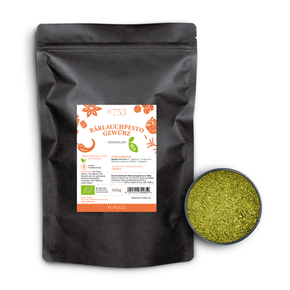 Bio Bärlauchpesto Gewürz in schwarzem Beutel, daneben eine kleine Schale mit grünem Gewürz.