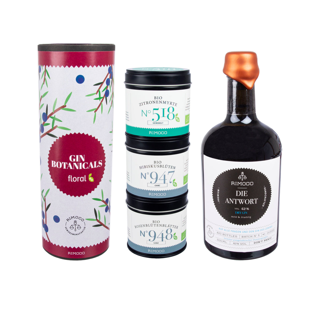 Vier Dosen und eine dunkle Flasche mit orangefarbenem Deckel, daneben florale Botanicals.