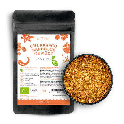 Bio Churrasco Barbecue Gewürz in orangener und weißer Verpackung, daneben eine Schale mit Gewürz.