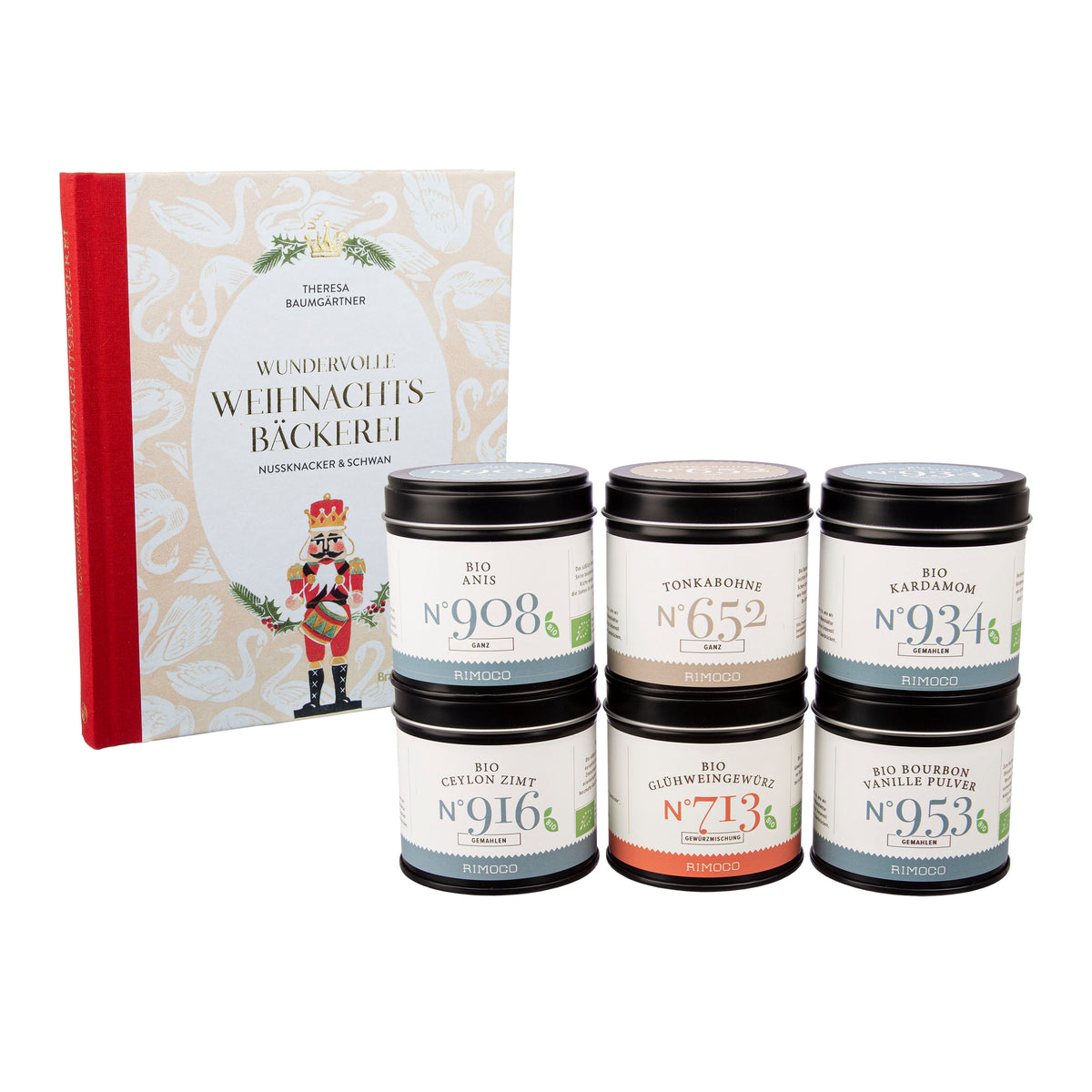 Sechs Gewürzdosen stehen vor dem Buch Geschenkset Wundervolle Weihnachtsbäckerei mit rotem Rücken.