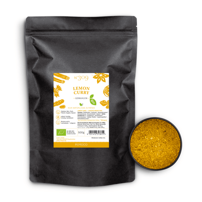 Bio Lemon Curry Beutel neben einer Schale mit leuchtend gelber, gemahlener Bio Lemon Curry Gewürzmischung.