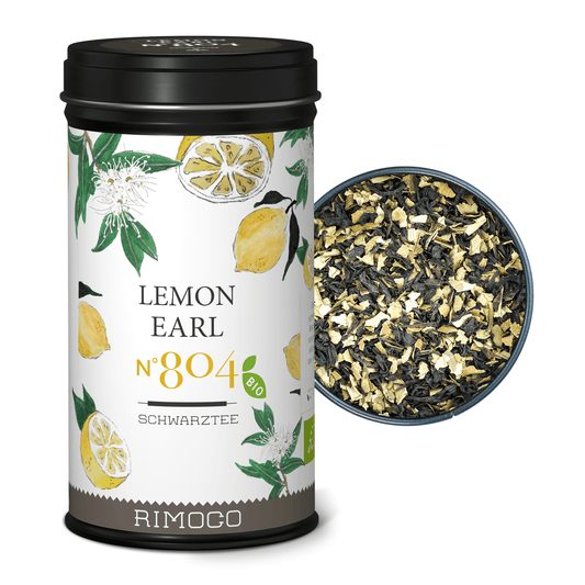 Bio Schwarztee Lemon Earl in Dose mit Zitronen auf dem Etikett, daneben lose Teeblätter im runden Behälter.