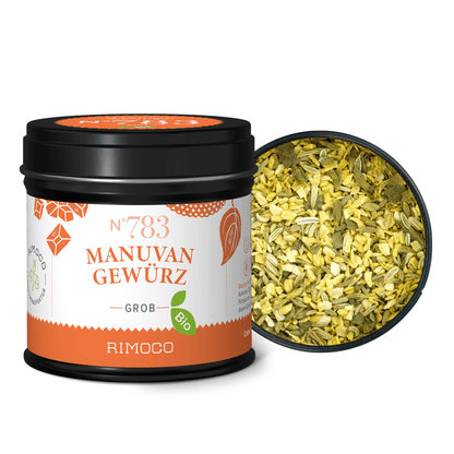 Schwarze Dose mit Aufschrift Bio Manuvan Gewürz, im Deckel grobe, bunte Gewürzmischung sichtbar.
