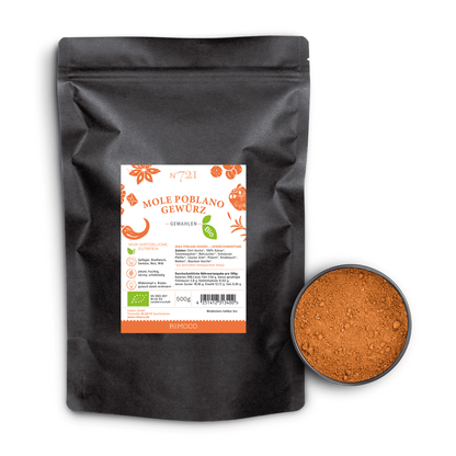 Bio Mole Poblano Gewürz neben einer Dose mit orange-brauner, gemahlener mexikanischer Gewürzmischung.
