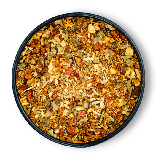 Runde schwarze Schale mit Bio Salatgewürz Mediterran, von oben fotografiert.